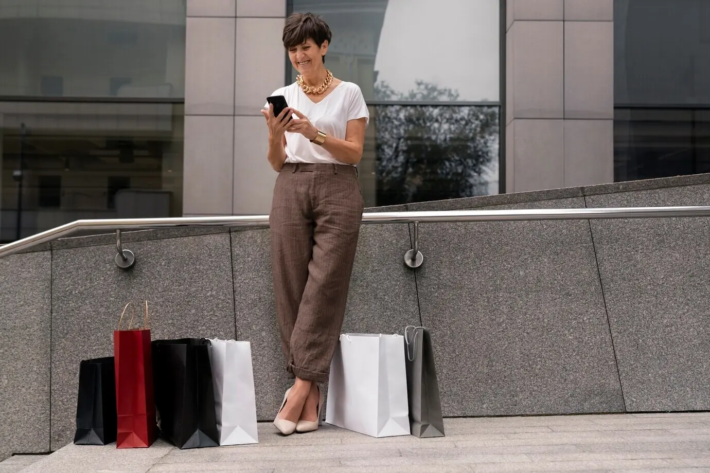 Full-body shot of a wealthy woman outdoors.